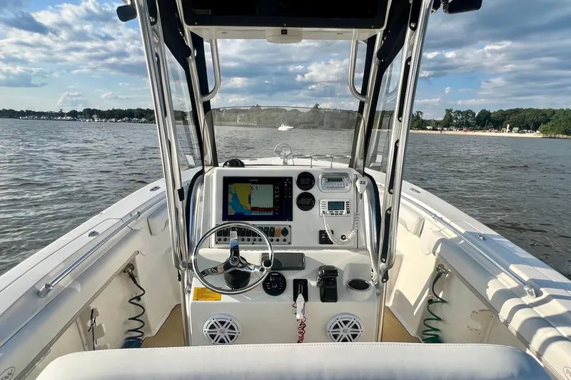 Slide: The Image of 2011 Key West 244 Center Console boat interior with steering wheel and navigation system. - 19