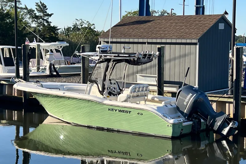 Slide: The Image of 2011 Key West 244 Center Console boat docked with Yamaha outboard motor. - 2