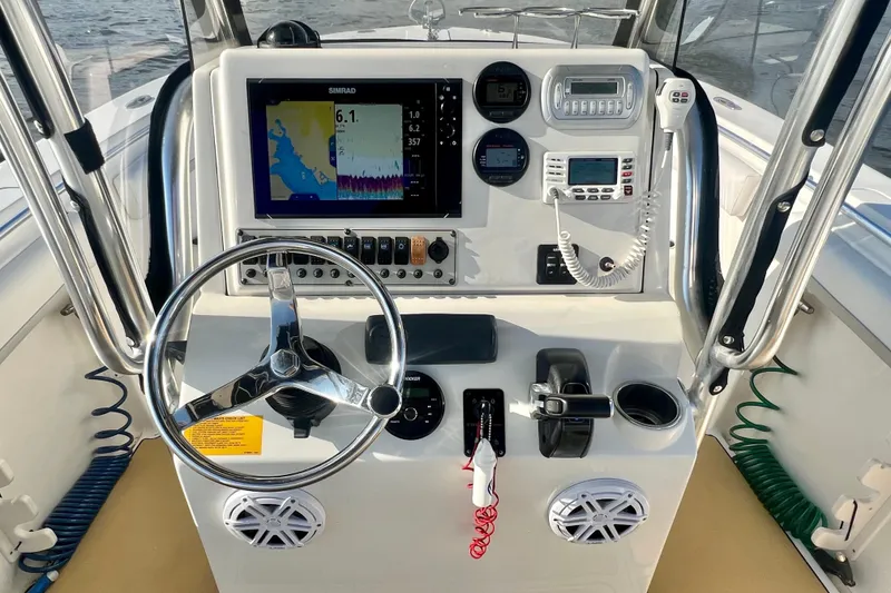 Slide: The Image of 2011 Key West 244 Center Console boat dashboard with navigation and control systems. - 20