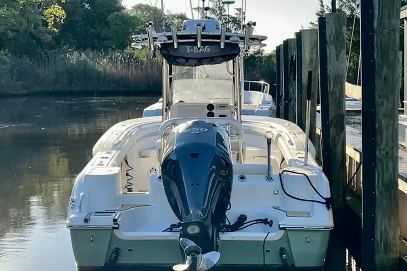 Slide: The Image of 2011 Key West 244 Center Console boat docked in a serene waterway. - 4