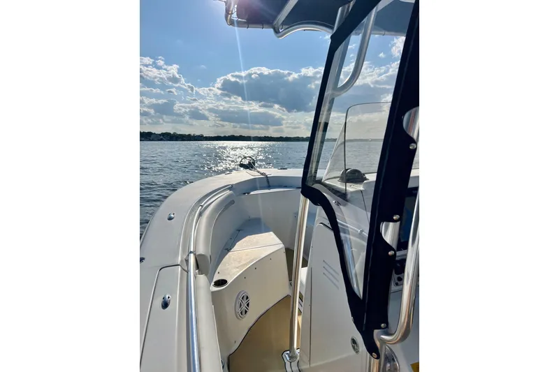 Slide: The Image of 2011 Key West 244 Center Console boat on a sunny day, cruising on calm waters. - 5