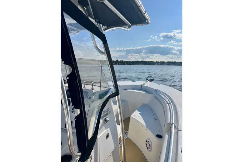 Slide: The Image of 2011 Key West 244 Center Console boat on calm water under a clear sky. - 6