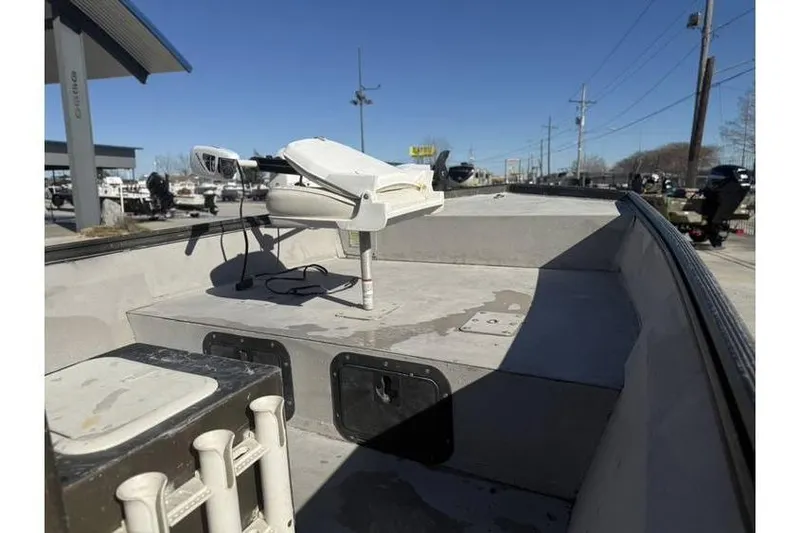 Slide: The Image of 2000 War Eagle 18ft CC boat interior with trolling motor, docked outdoors. - 10