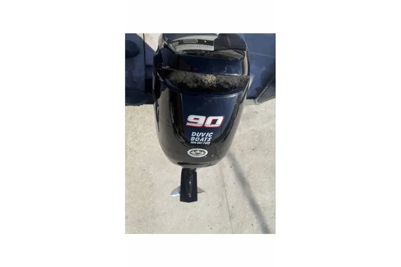Slide: The Image of Outboard motor on a 2000 War Eagle 18ft CC boat, labeled "90 Duvic Boats." - 12