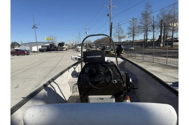 Slide: The Image of 2000 War Eagle 18ft CC boat with Humminbird electronics, parked outdoors on a sunny day. - 4
