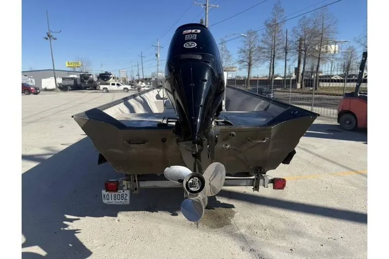 Slide: The Image of Rear view of a 2000 War Eagle 18ft CC boat with an outboard motor. - 7