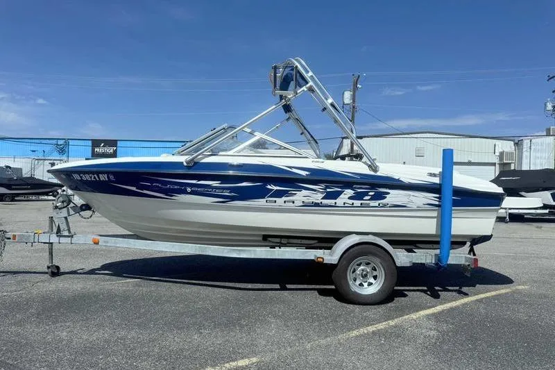 The Image of 2008 Bayliner Element F18 boat on trailer in parking lot. - 0