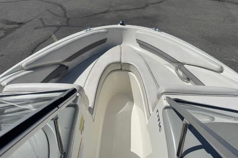 Slide: The Image of 2008 Bayliner Element F18 boat interior with white seating and gray accents. - 11