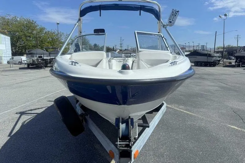 Slide: The Image of 2008 Bayliner Element F18 boat on trailer in parking lot, sunny day. - 3