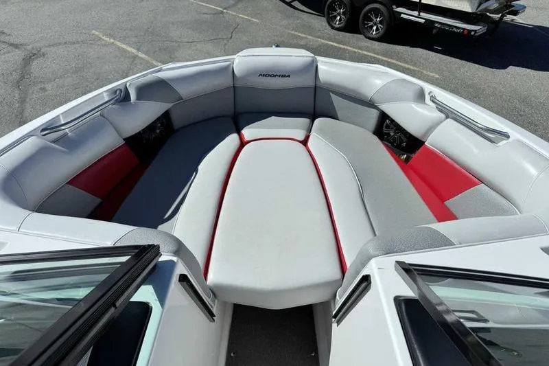 Slide: The Image of 2016 Moomba Mojo boat interior with gray and red seating, spacious bow area. - 12
