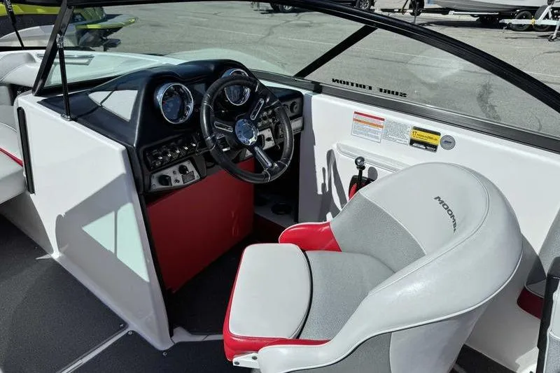 Slide: The Image of 2016 Moomba Mojo boat interior with steering wheel and dashboard controls. - 13
