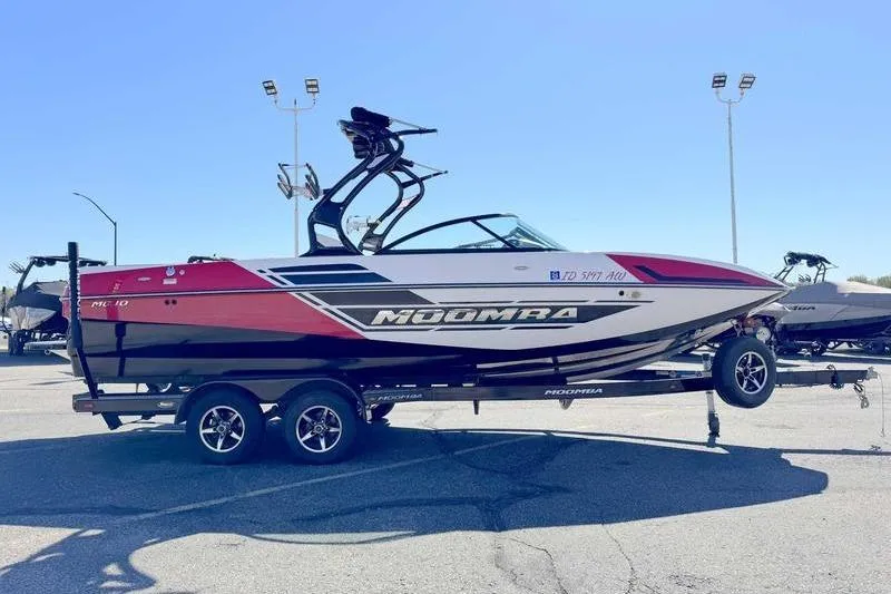 Slide: The Image of 2016 Moomba Mojo boat on trailer in parking lot, front view. - 2