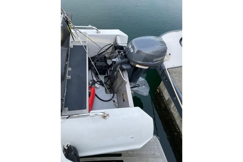 Slide: The Image of Outboard motor on a 1981 Cheer Men PT 38 Europa boat docked by the water. - 10