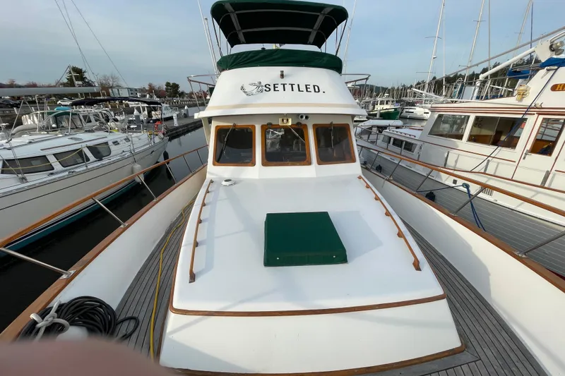 Slide: The Image of 1981 Cheer Men PT 38 Europa yacht docked in a marina, featuring a spacious deck. - 12