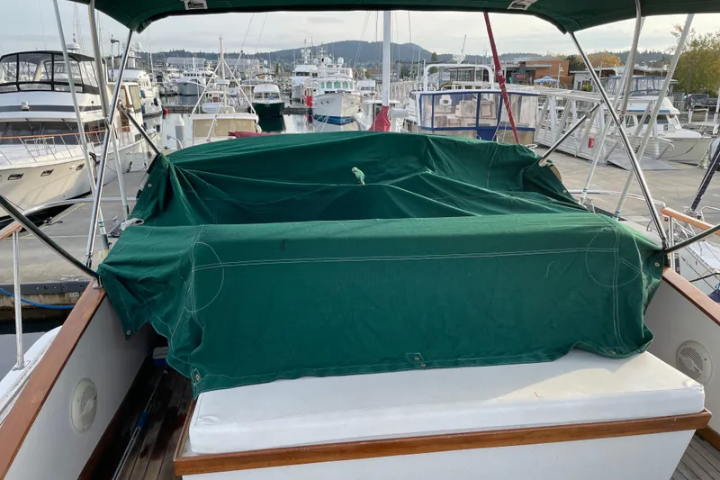 Slide: The Image of 1981 Cheer Men PT 38 Europa boat with green cover at marina. - 17