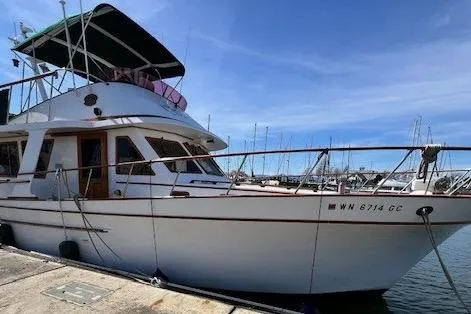 Slide: The Image of 1981 Cheer Men Marine PT 38 Europa yacht docked at marina under clear blue sky. - 2