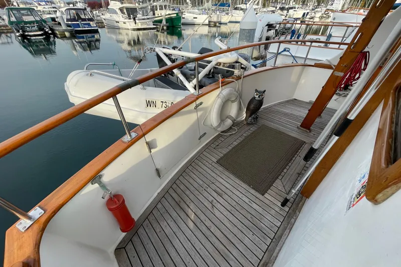 Slide: The Image of 1981 Cheer Men PT 38 Europa yacht deck with lifebuoy and owl statue. - 21