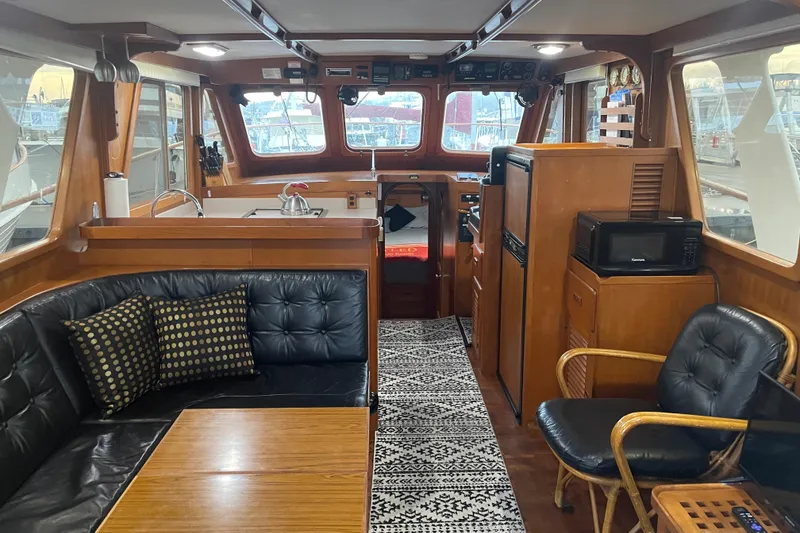 Slide: The Image of Interior of 1981 Cheer Men PT 38 Europa yacht with cozy seating and kitchen area. - 23