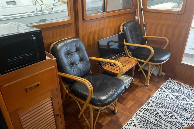 Slide: The Image of Interior of 1981 Cheer Men PT 38 Europa with wicker chairs and nautical decor. - 27