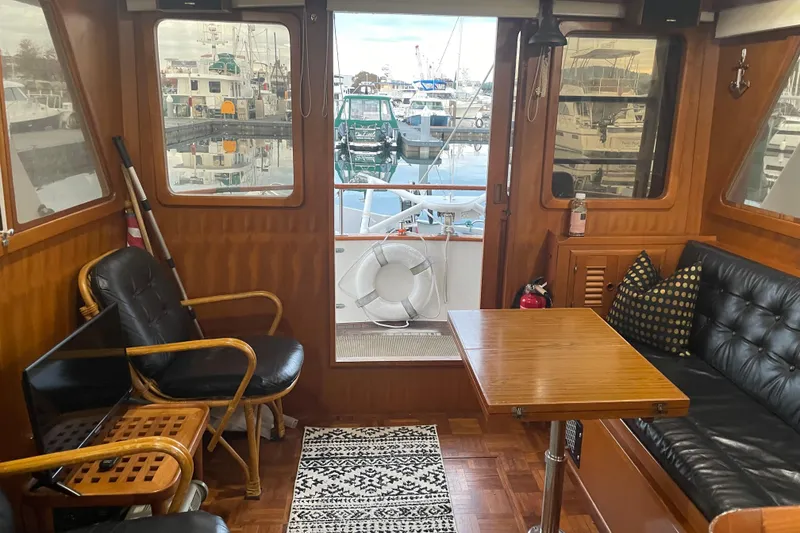 Slide: The Image of Interior of 1981 Cheer Men PT 38 Europa yacht with cozy seating and marina view. - 28