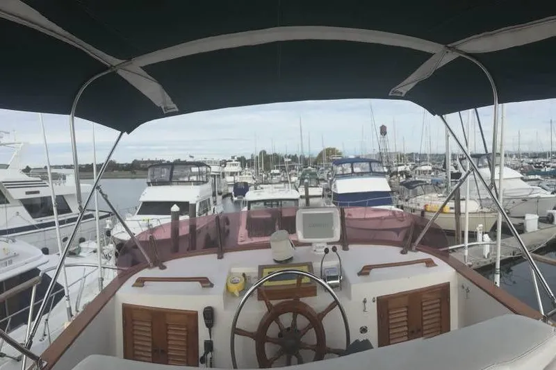 Slide: The Image of 1981 Cheer Men PT 38 Europa yacht helm view at marina, surrounded by boats. - 3