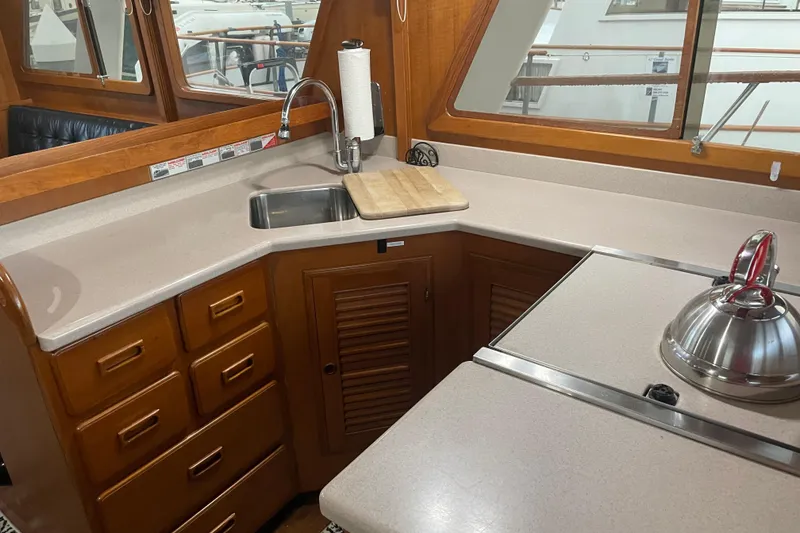 Slide: The Image of 1981 Cheer Men PT 38 Europa yacht kitchen with wooden cabinets and modern sink. - 30