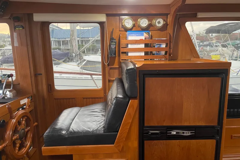 Slide: The Image of Interior of 1981 Cheer Men PT 38 Europa boat with wooden helm and leather seat. - 32