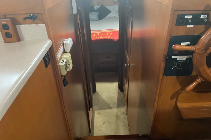 Slide: The Image of Interior of 1981 Cheer Men PT 38 Europa boat, featuring a cozy cabin and wooden steering wheel. - 37