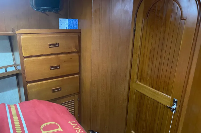 Slide: The Image of Wood-paneled cabin interior of 1981 Cheer Men PT 38 Europa yacht, featuring drawers and door. - 39