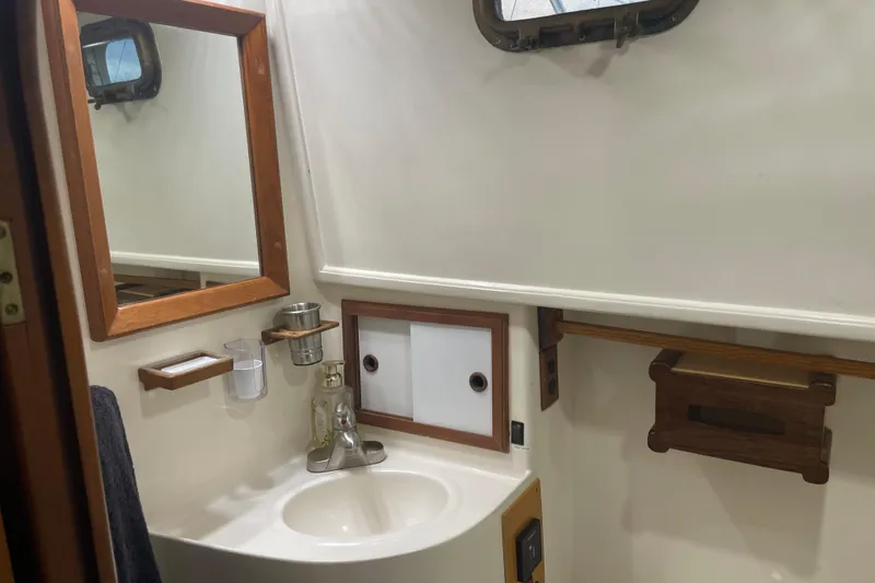 Slide: The Image of 1981 Cheer Men PT 38 Europa yacht bathroom with sink, mirror, and wooden accents. - 43