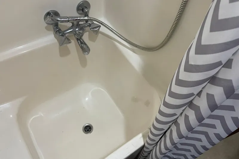 Slide: The Image of Bathtub with chrome faucet and chevron-patterned shower curtain, Cheer Men PT 38 Europa, 1981. - 47