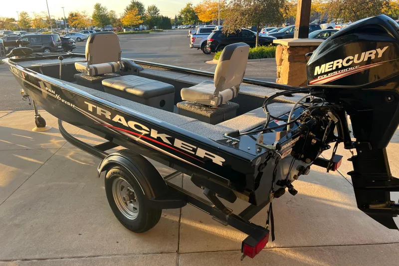Slide: The Image of 2020 Tracker Panfish 16 boat with Mercury engine in parking lot. - 2
