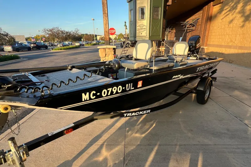 Slide: The Image of 2020 Tracker Panfish 16 boat parked outdoors, featuring a sleek black design. - 3