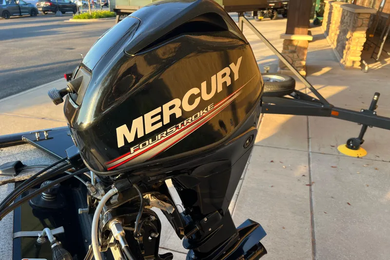 Slide: The Image of Mercury FourStroke engine on 2020 Tracker Panfish 16 boat, parked on pavement. - 6