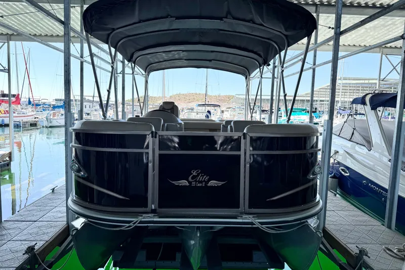 Slide: The Image of 2017 Bentley Pontoons 223 Cruise docked in a marina under a covered structure. - 11