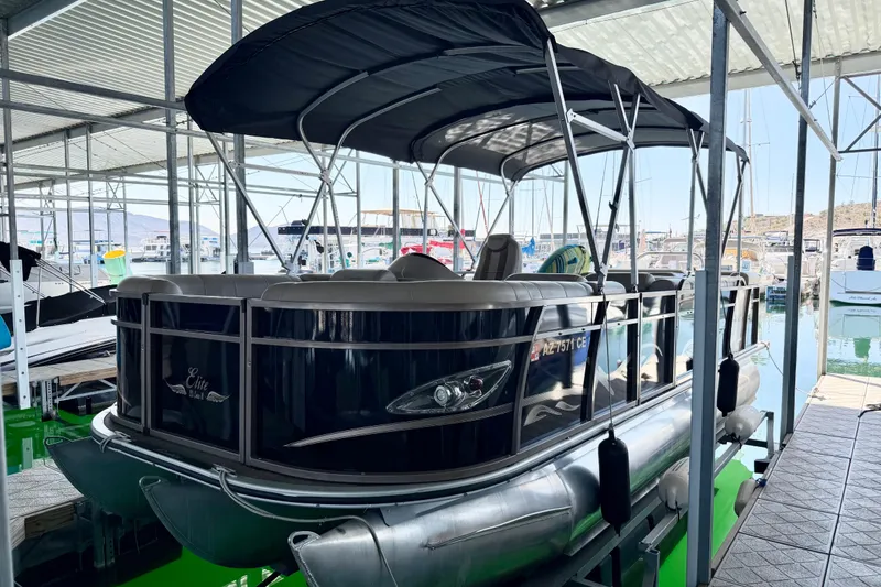 Slide: The Image of 2017 Bentley Pontoons 223 Cruise in marina, covered dock, sleek design, luxury seating. - 12