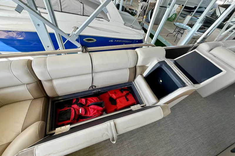 Slide: The Image of 2017 Bentley Pontoons 223 Cruise with open storage compartment and life jackets. - 16