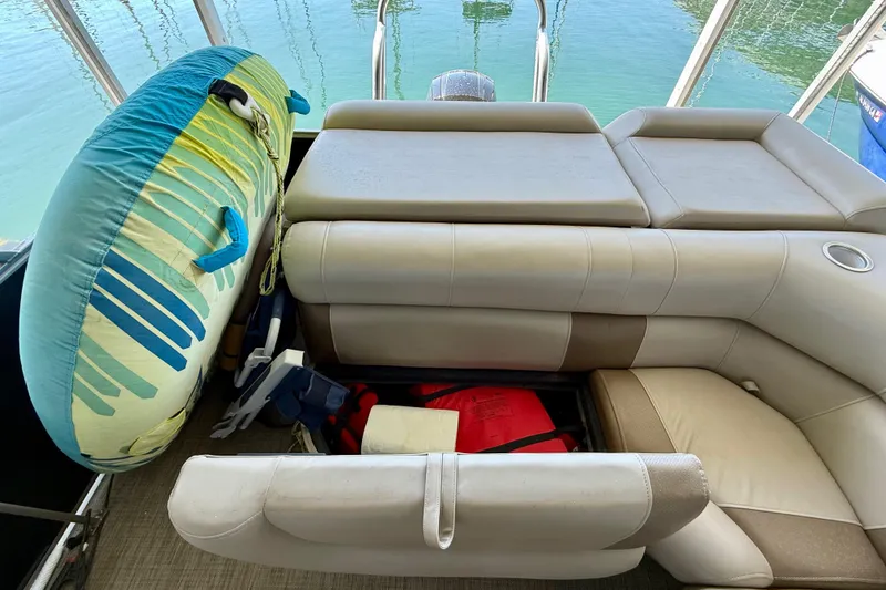 Slide: The Image of 2017 Bentley Pontoons 223 Cruise interior with storage, life jackets, and inflatable tube. - 17
