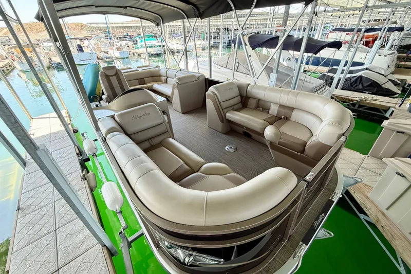 Slide: The Image of 2017 Bentley Pontoons 223 Cruise with luxurious seating at a marina. - 6