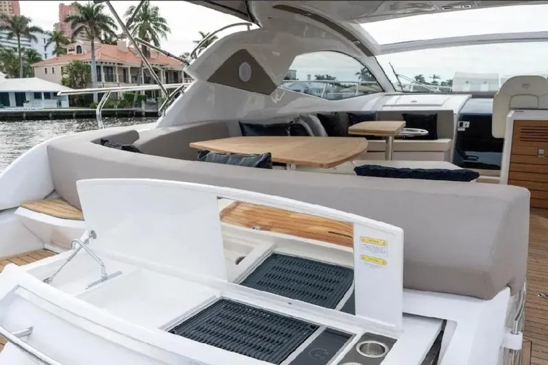 Slide: The Image of 2024 Sessa Marine C44 Cruiser with elegant outdoor seating and dining area. - 10