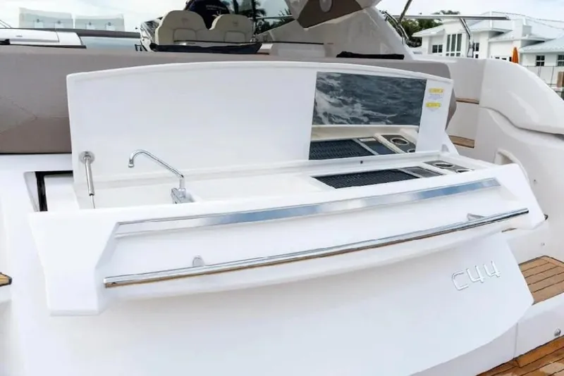 Slide: The Image of 2024 Sessa Marine C44 Cruiser, docked with palm trees in the background. - 12