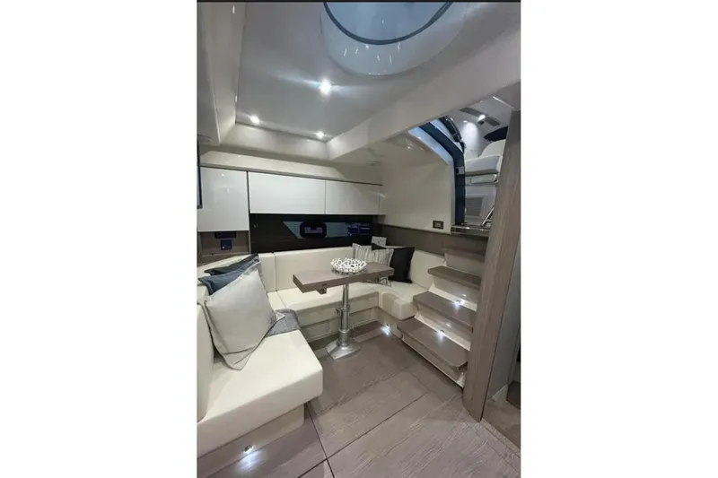 Slide: The Image of Luxurious bathroom in 2024 Sessa Marine C44 Cruiser with modern fixtures and wooden cabinetry. - 14