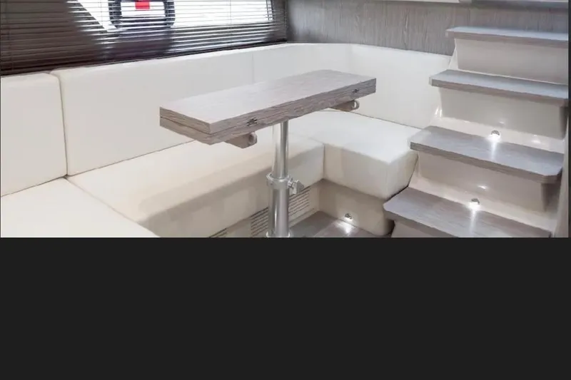 Slide: The Image of Luxurious interior of 2024 Sessa Marine C44 Cruiser with elegant seating and dining area. - 3