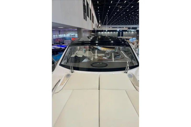 Slide: The Image of 2024 Sessa Marine C44 Cruiser with outdoor kitchen on deck, docked by waterfront homes. - 9