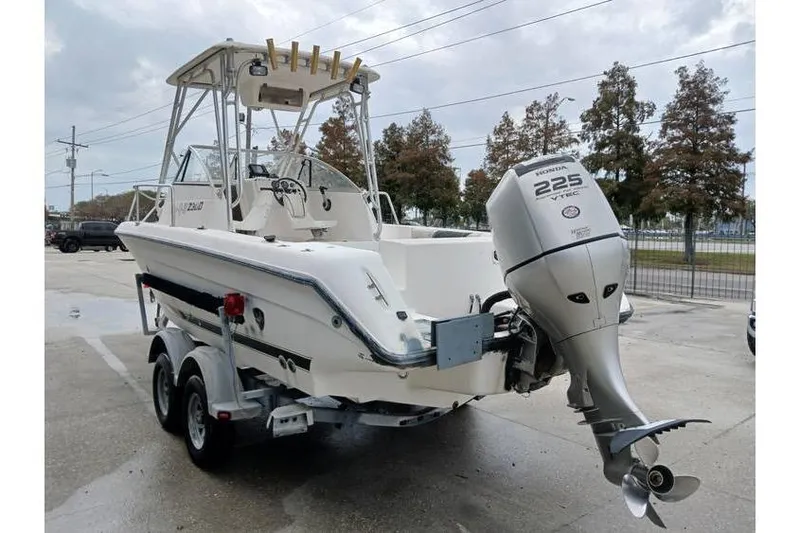 Slide: The Image of 1999 Century 2300 Walk-Around boat with Honda 225 outboard motor on trailer. - 3