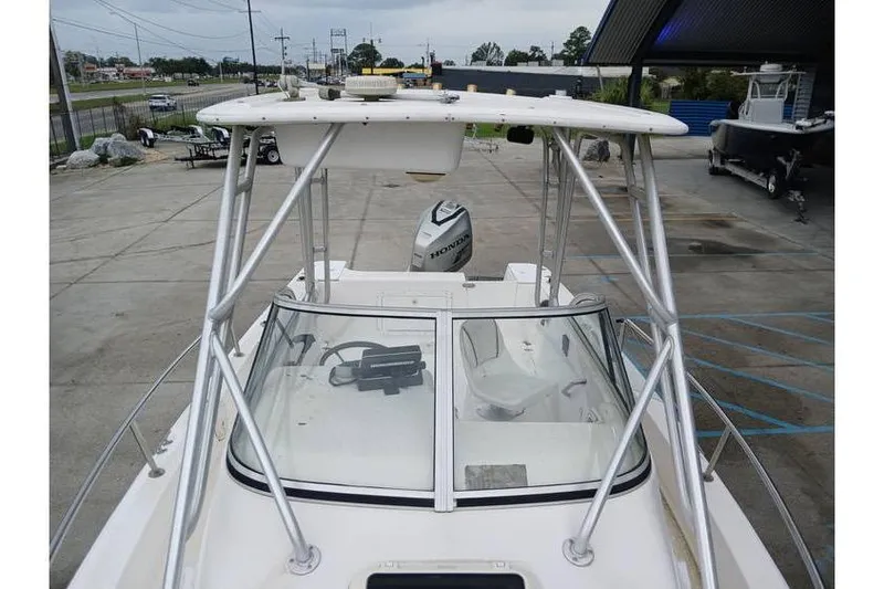 Slide: The Image of 1999 Century 2300 Walk-Around boat with Honda outboard motor, docked in a marina. - 5