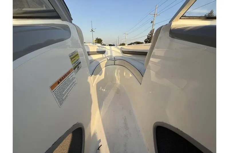 Slide: The Image of 2008 Bayliner 185 Bowrider interior view with seating and warning label. - 11