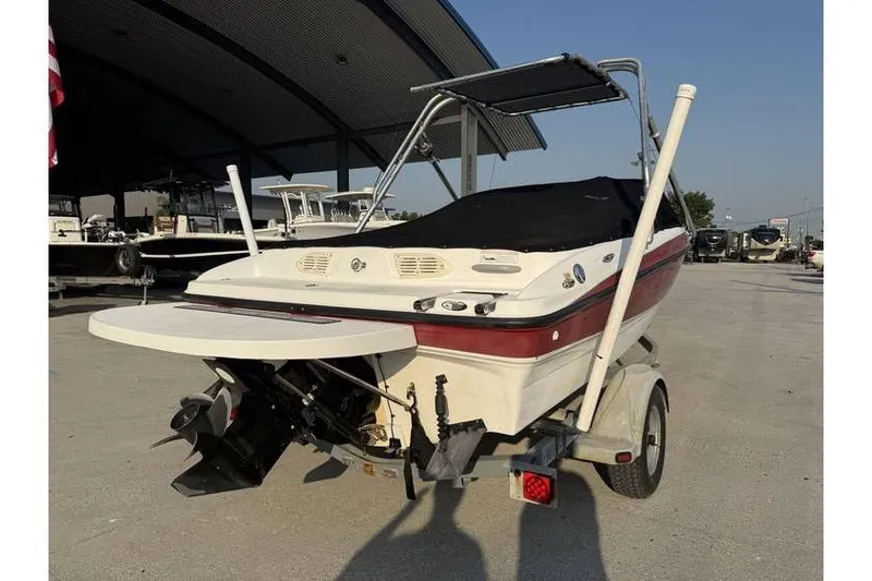 Slide: The Image of 2008 Bayliner 185 Bowrider boat on trailer, rear view, under a canopy. - 4