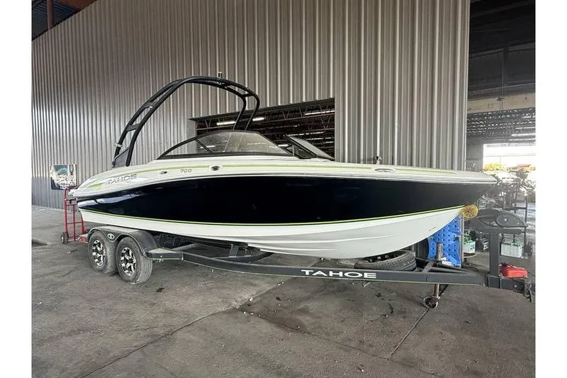 The Image of 2019 Tahoe 700 boat on trailer in warehouse setting. - 1