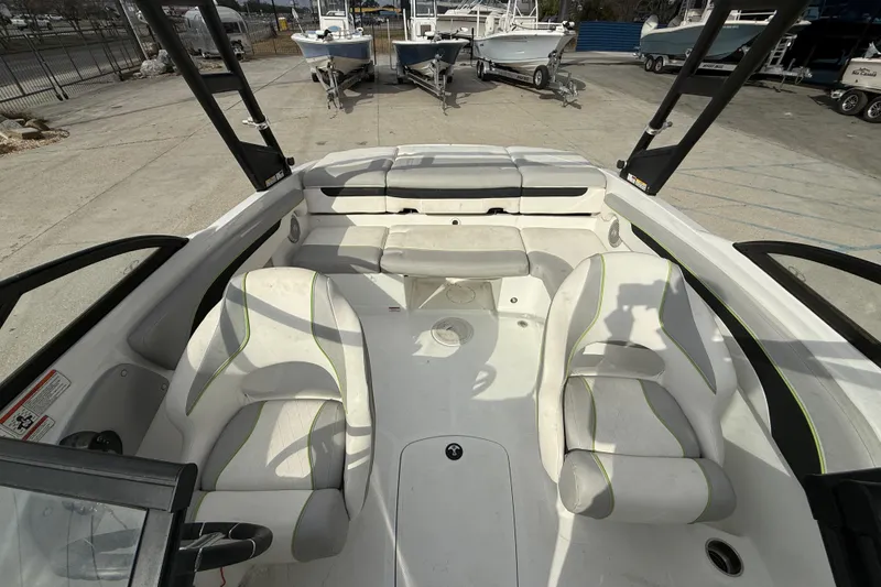 Slide: The Image of Interior of a 2019 Tahoe 700 boat with white seating and open deck layout. - 10
